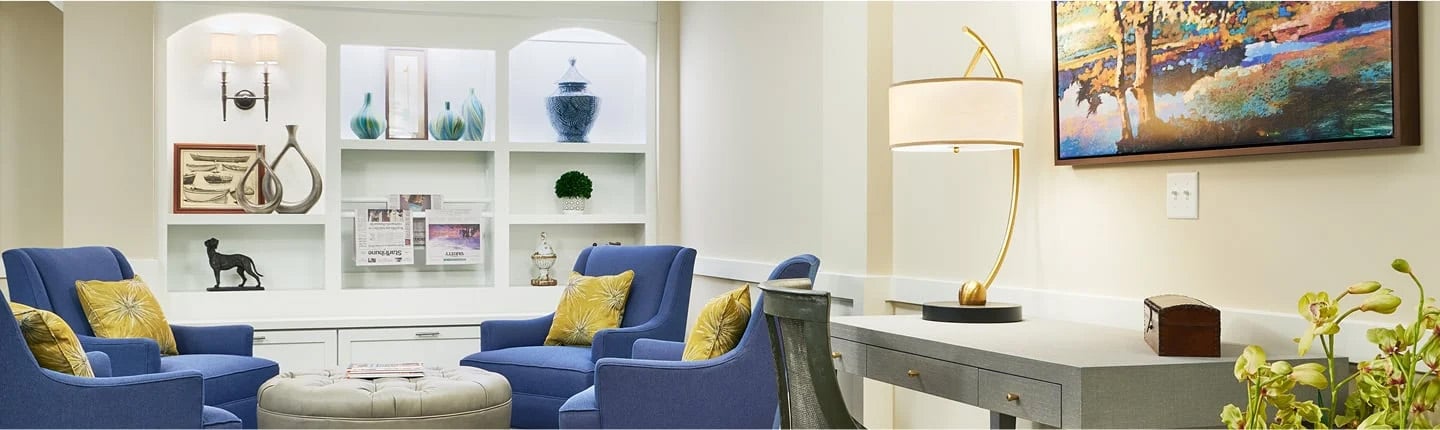 living room with bright lights and four blue chairs