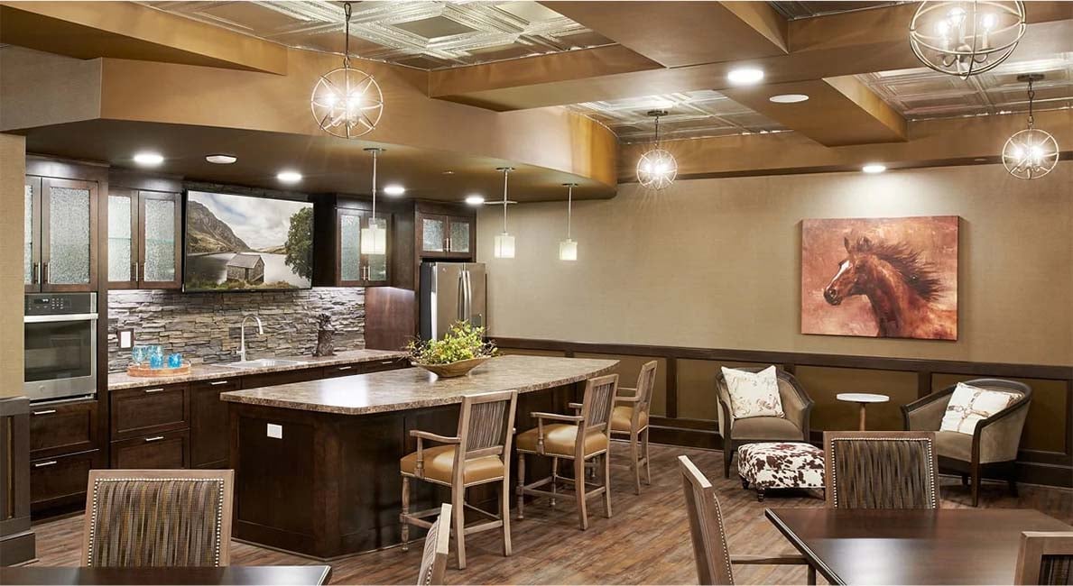 a bright kitchen with brown cabinets, table and chairs