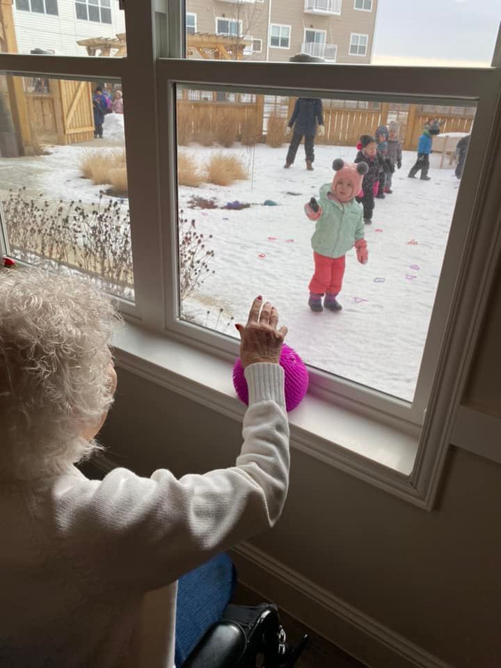 Kids search for Valentine’s Day hearts from their Riley Crossing Grandfriends
