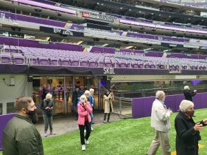 Senior living residents walk on the Minnesota Vikings playing field