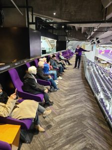 Riley Crossing residents sitting in top-level seats during Vikings stadium tour