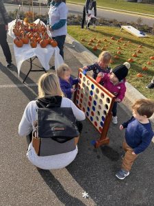 Childcare children playing large checkers at the Fall Festival